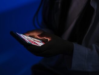 A person using a smartphone in a dark setting